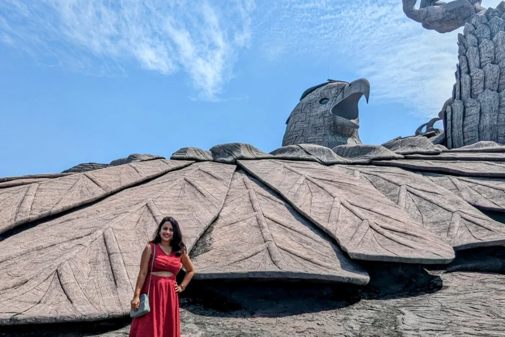 A lady with backdrop of Jatayu Sculpture in Kerala